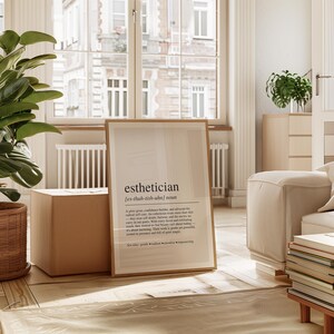 a living room with a plant and a poster on the floor