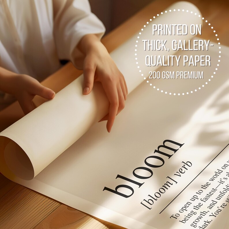 A person is holding a roll of paper with the word "bloom" printed on it, and there is a printed statement about the quality of the paper.