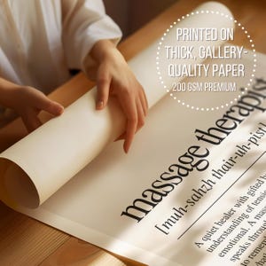 a person holding a roll of paper on top of a table