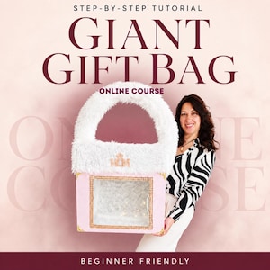 May include: A giant gift bag with a white faux fur handle and top trim, a light pink body, and a square transparent window framed in gold. The text reads STEP-BY-STEP TUTORIAL GIANT GIFT BAG ONLINE COURSE BEGINNER FRIENDLY with MOM in gold.