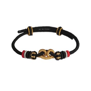 May include: A black cord bracelet featuring a central gold-colored knot ornament. The bracelet is accented with small gold-colored beads, red and silver thread detailing, and adjustable sliding knots for a secure fit on the wrist.