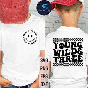 May include: White t-shirt with black text and a smiley face graphic. The text reads "Young Wild & Three".