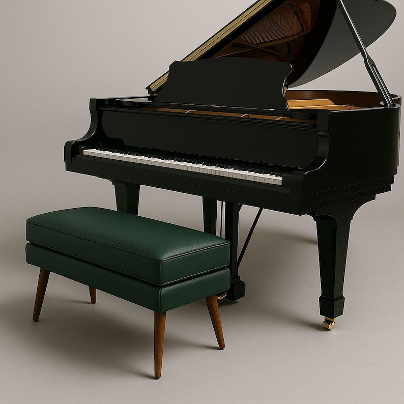 May include: A black grand piano with a matching green bench. The piano has a glossy finish, a keyboard with white and black keys, and a music stand. The bench has a rectangular green cushion and wooden legs.
