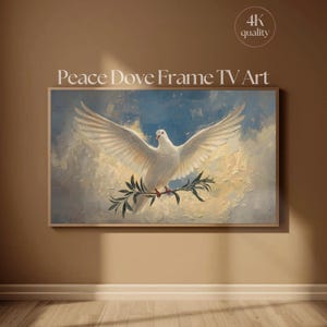 May include: A framed artwork titled "Peace Dove Frame TV Art" depicts a white dove with outstretched wings, holding an olive branch. The background features a cloudy sky with blue and yellow hues. The artwork is displayed on a brown wall.