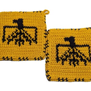 May include: Two square, handmade crochet potholders. The potholders are yellow with a black eagle design in the centre. The edges are finished with a black stitch. Each potholder has a small loop for hanging.