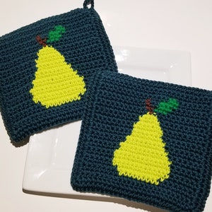 May include: Two handmade, square potholders. The potholders are dark teal with a bright yellow pear design. The pear has a green leaf and a brown stem. Each potholder has a small loop for hanging.