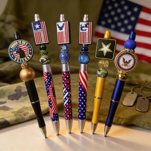 May include: A white ceramic mug with a black handle and the text "But First, Coffee" in a bold, black font. The mug is set against a blurred background, suggesting a cozy setting.