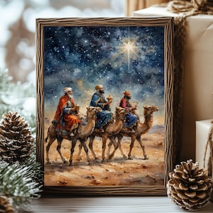 May include: A framed watercolor painting depicts the three wise men on camels, traveling under a starry night sky towards a bright star. The artwork features rich colors and a desert landscape, evoking a sense of journey and faith. The frame is made of wood.