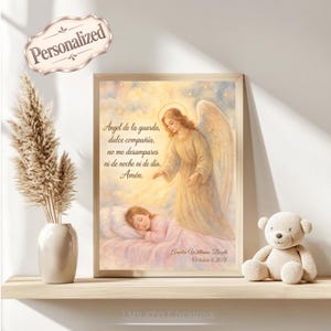May include: A framed wall art print featuring a guardian angel watching over a sleeping child in bed. The artwork includes the Spanish prayer Angel de la guarda, dulce compañía, no me desampares ni de noche ni de día. Amén, with custom text below.
