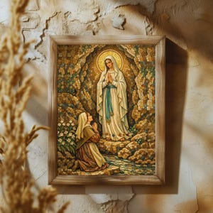 May include: A framed mosaic artwork depicting a religious scene. The artwork features two figures, one kneeling and one standing, within a cave-like setting. The standing figure is wearing a white robe with a blue sash and a golden halo. The artwork is framed in a light brown wooden frame.
