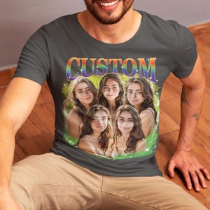 May include: A dark gray t-shirt with the word "CUSTOM" printed in rainbow letters. The shirt features a collage of five photos of people with a green and blue background.