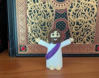 Mini Jesus Figurine Arms Outstretched – 2” White Religious Statue with Purple Sash – Loving Welcoming Pose