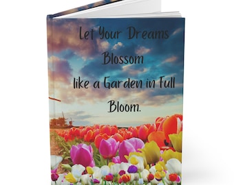 May include: A closed book with a colorful image of a field of tulips and a quote that reads "Let your dreams blossom like a garden in full bloom."