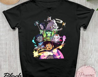 May include: Black t-shirt featuring a colorful graphic of animated characters. The design includes characters with various skin tones and hair colors, set against a background of purple and yellow. The word "Black" is printed on the lower left.