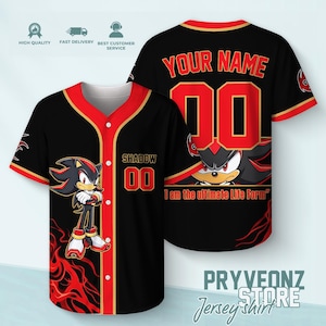 May include: A black and red baseball jersey featuring a graphic of the character Shadow the Hedgehog on the front, along with the text SHADOW and the number 00. The back displays the text YOUR NAME and the number 00 with a Shadow graphic.
