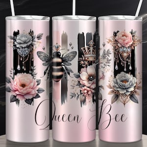 May include: Three stainless steel tumblers with a pink background and a floral design. The tumblers feature a bee, a crown, and a jeweled pendant. The text "Queen Bee" is printed on the tumblers.