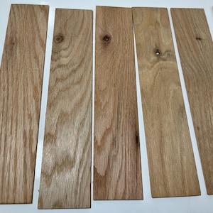 May include: Six wooden planks, each approximately 12 inches long and 2 inches wide, with a natural wood finish. The planks have a light brown color and a grain pattern.