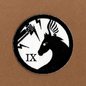 May include: Black and white embroidered patch featuring a stylised horse head and lightning bolt design. The patch has the Roman numeral "IX" in the centre.