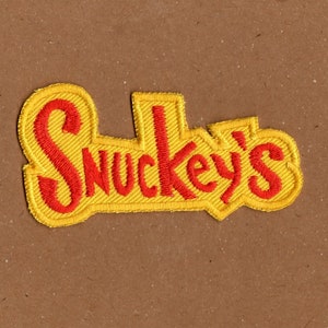 May include: Yellow embroidered patch with the text "Snukey's" in red.