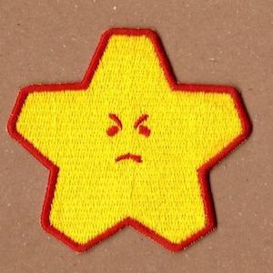 May include: Embroidered yellow star patch with a red border. The star has an angry face with red eyes and a frown. The patch is likely for clothing or accessories.