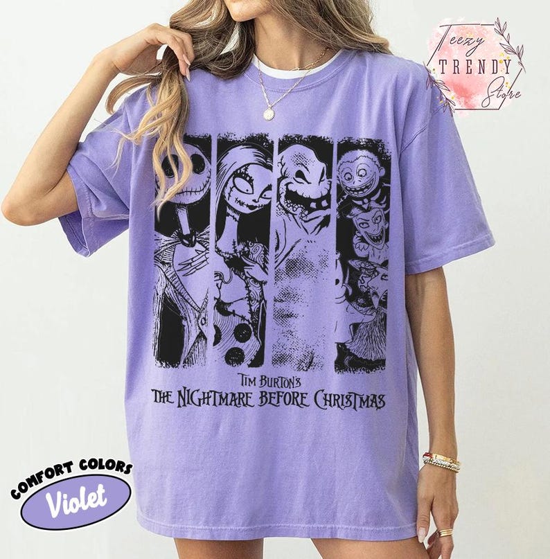 May include: A violet short-sleeve t-shirt featuring a black graphic print of characters from Tim Burton's The Nightmare Before Christmas. The design consists of four vertical panels displaying Jack Skellington, Sally, Oogie Boogie, and Lock, Shock, and Barrel.