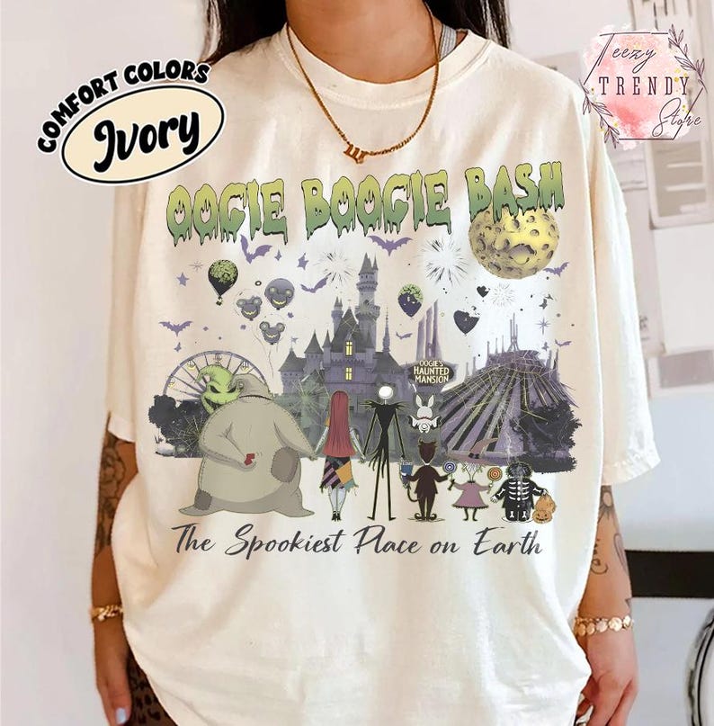May include: An ivory t-shirt featuring a graphic print with the text OOGIE BOOGIE BASH and The Spookiest Place on Earth. The design includes a castle, a moon, bats, balloons, and various animated characters from a dark fantasy film setting.