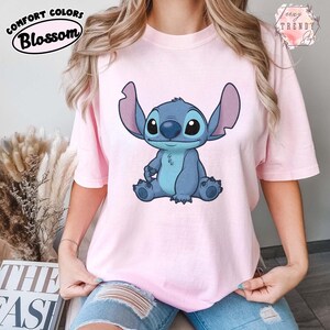 May include: A white ceramic mug with a black handle and the text "But First, Coffee" in a black, handwritten-style font. The mug is on a white surface.