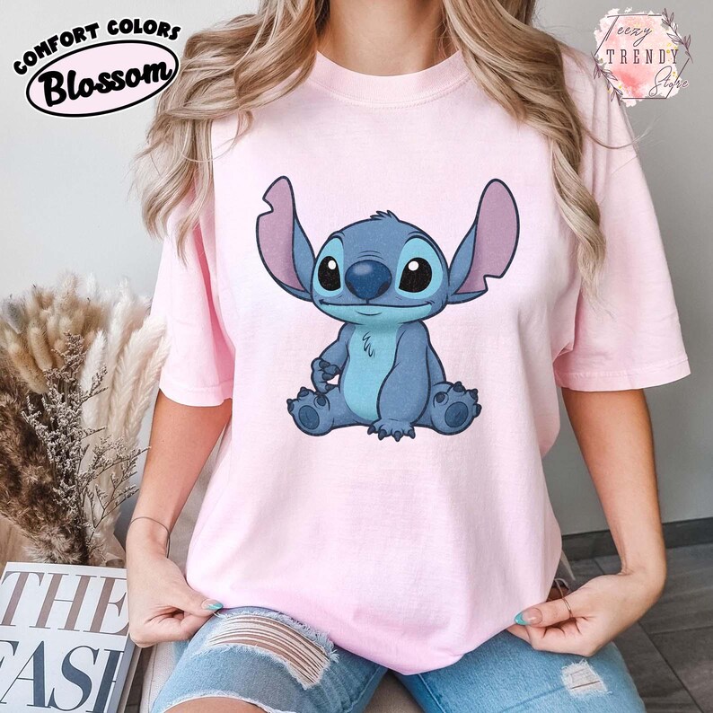 May include: A white ceramic mug with a black handle and the text "But First, Coffee" in a black, handwritten-style font. The mug is on a white surface.