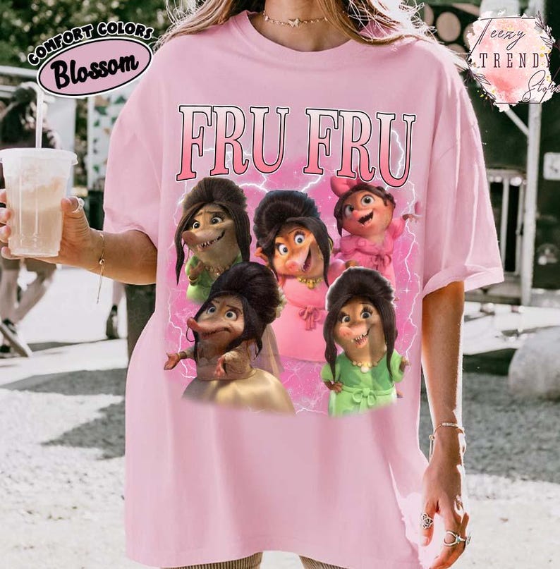 Puede incluir: Camiseta rosa p&aacute;lido Comfort Colors con el texto "FRU FRU" en rosa. La camiseta presenta un gr&aacute;fico de seis personajes de dibujos animados con varios atuendos. La camiseta tiene un corte holgado y mangas cortas.