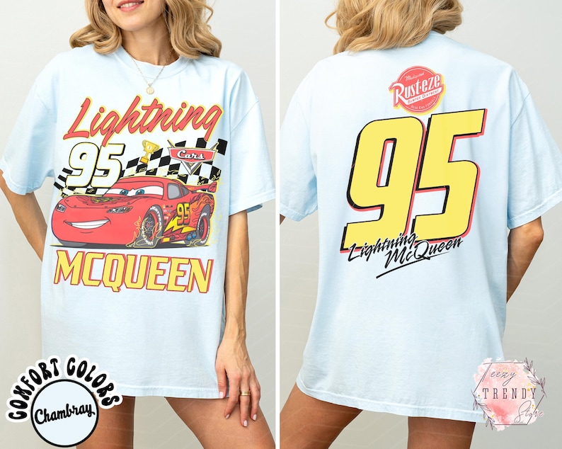 May include: Light blue t-shirt featuring Lightning McQueen from the Cars movie. The front graphic shows McQueen with the number 95, a checkered flag, and the text "Lightning McQueen". The back displays a large number 95 and the text "Lightning McQueen".