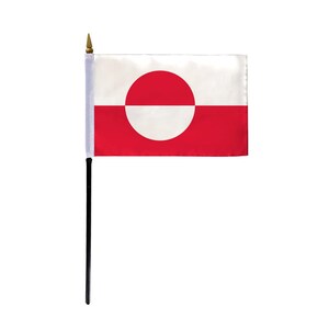 May include: A small desk flag of Greenland. The flag is red with a white circle in the center. The circle is offset to the left and has a white horizontal line across the top.