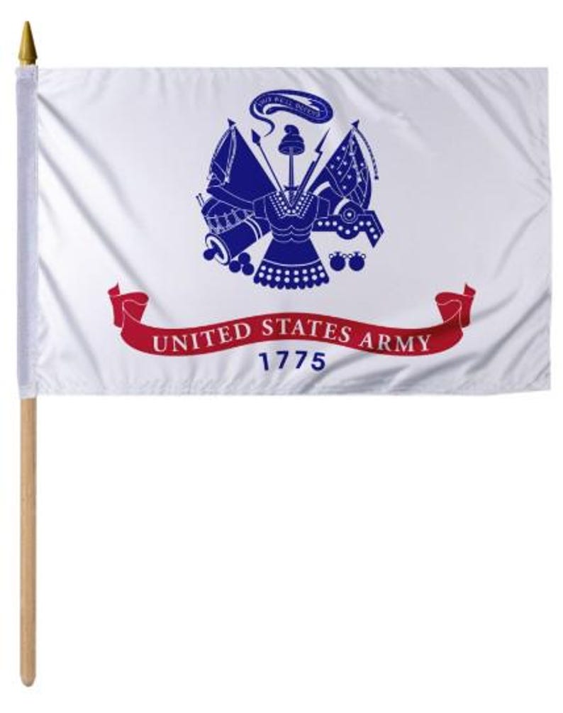 May include: A white flag with the United States Army emblem in blue and a red banner that reads "UNITED STATES ARMY 1775." The flag is mounted on a wooden pole with a gold-colored tip.