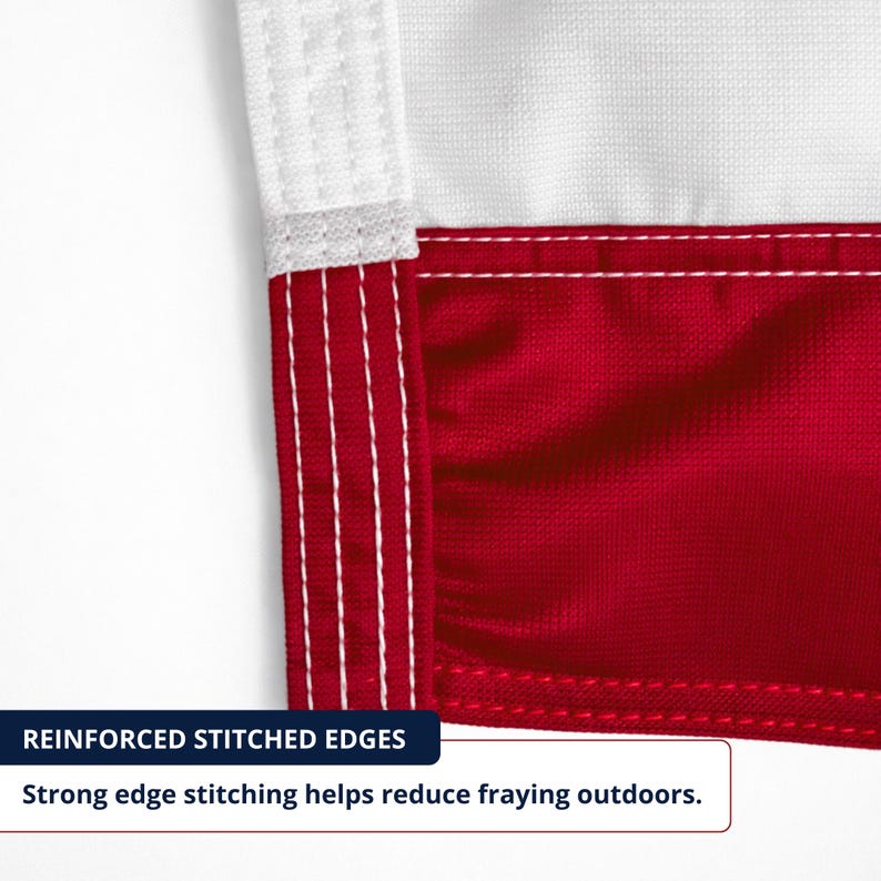 May include: Detail of a red and white flag corner. The flag has reinforced stitched edges with strong stitching to reduce fraying. The white section is at the top, and the red section is below.