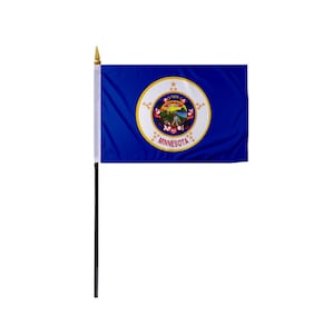 May include: A blue Minnesota state flag with a white circle in the center. The circle contains a gold seal with a depiction of a farmer plowing a field, a gristmill, and a steamboat. The seal is surrounded by 19 gold stars and the word "MINNESOTA" in gold letters.