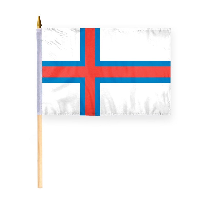 May include: A white flag with a red cross on a blue background. The flag is on a wooden pole.