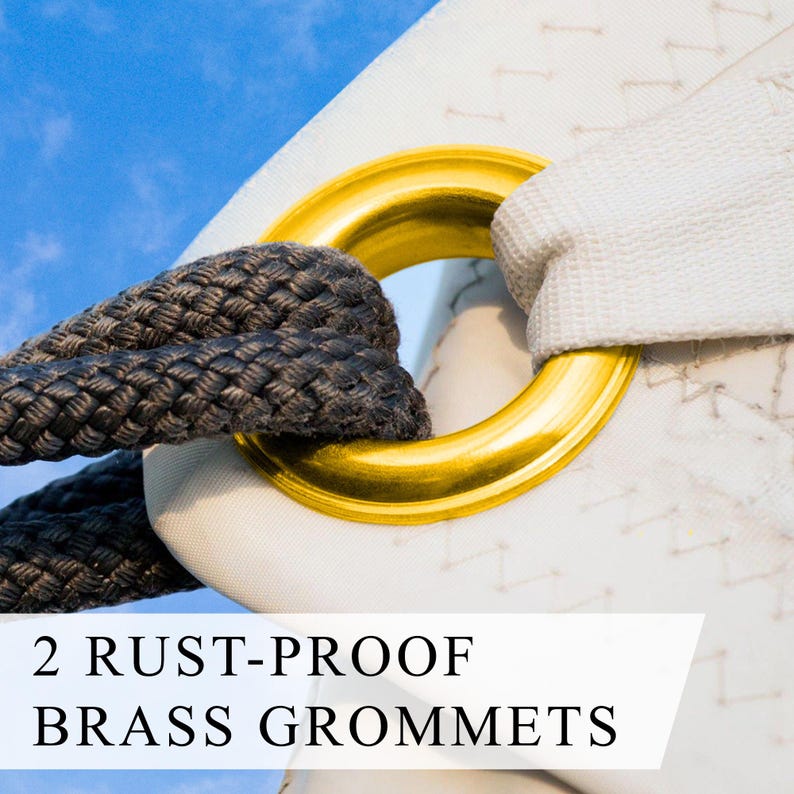 May include: Close-up of a white fabric with a gold-colored brass grommet and a dark gray rope. The text "2 RUST-PROOF BRASS GROMMETS" is displayed on the bottom of the image. The background is a clear blue sky.