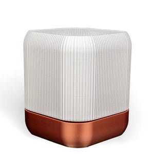 May include: A white ceramic lamp with a copper base. The lamp has a ribbed design and a square shape.