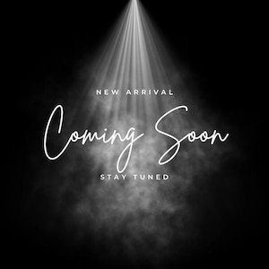 May include: A spotlight shines on a white background with the text "NEW ARRIVAL" and "Coming Soon" in a handwritten font. The text "STAY TUNED" is below the main text.