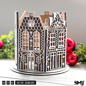 May include: A brown and white laser-cut wooden lantern featuring a gingerbread house design with intricate scrollwork, arched windows, and heart-shaped accents. The structure is circular, composed of multiple panels with detailed cutouts.