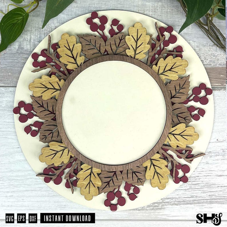 May include: A circular wooden sign featuring a layered design with a central blank circle surrounded by gold and dark brown oak leaves and clusters of maroon berries. The sign is mounted on a light cream circular base with text at the bottom.