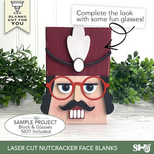 Puede incluir: Una pieza de madera cortada con l&aacute;ser que representa un rostro de cascanueces con sombrero granate, pluma blanca, bigote negro y cara clara. El texto dice: BLANKS CUT FOR YOU, Complete the look with some fun glasses!, y SAMPLE PROJECT Block & Glasses NOT INCLUDED.