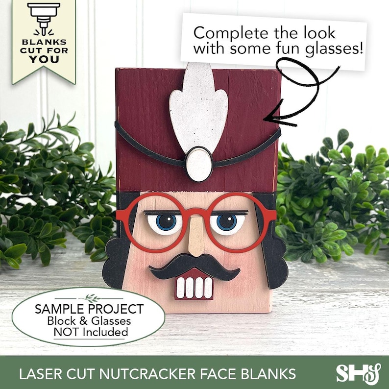Puede incluir: Una pieza de madera cortada con l&aacute;ser que representa un rostro de cascanueces con sombrero granate, pluma blanca, bigote negro y cara clara. El texto dice: BLANKS CUT FOR YOU, Complete the look with some fun glasses!, y SAMPLE PROJECT Block & Glasses NOT INCLUDED.
