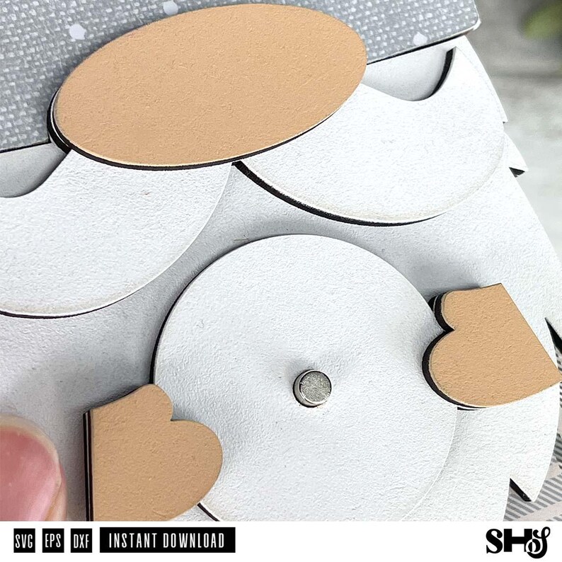 May include: A layered paper craft design featuring a tan oval nose, a white circular body with a small central metal stud, and two tan heart-shaped accents. The top section shows a grey patterned paper with white dots. Text reads SVG EPS DXF INSTANT DOWNLOAD.