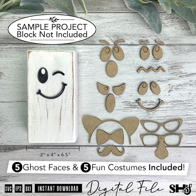 May include: A white rectangular wooden block with a black winking ghost face, accompanied by five sets of laser-cut wooden facial features and costume accessories including eyes, mouths, glasses, a mustache, and a bow tie for crafting projects.