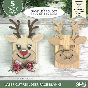 May include: Two laser-cut wooden reindeer face blanks, one finished with paint and a red patterned bow, the other unfinished natural wood. Each features a rectangular base, antlers, and ears. A measurement label indicates 2" x 4" x 4.75".