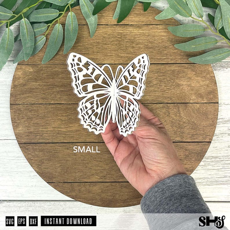 May include: A white, laser-cut butterfly cutout with intricate, symmetrical wing patterns. The butterfly is held in place and features the word SMALL printed in white text below it. The design is intended for digital use as an instant download.