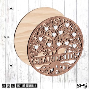 May include: A circular wooden wall art piece featuring a laser-cut tree design with the word GRANDKIDS and multiple small white heart-shaped cutouts integrated into the branches. A vertical arrow indicates a height of 12 inches for the item.