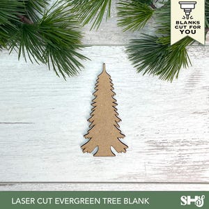 May include: A flat, laser-cut wooden evergreen tree shape with a pointed top and jagged branches. The cutout has a light brown, natural wood finish. A small banner in the top right corner features a graphic icon and the text BLANKS CUT FOR YOU.