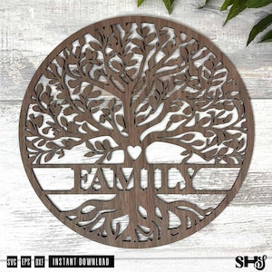 May include: A circular dark brown wooden wall art piece featuring a laser-cut tree of life design. The intricate branches and roots frame a central horizontal bar with the word FAMILY cut out in capital letters and a small heart above it.