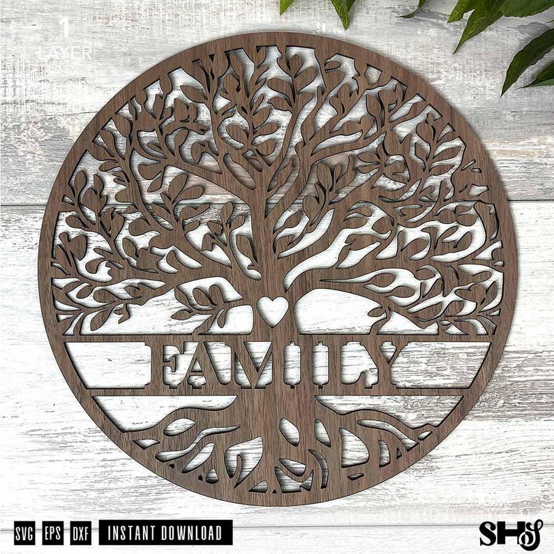 May include: A circular dark brown wooden wall art piece featuring a laser-cut tree of life design. The intricate branches and roots frame a central horizontal bar with the word FAMILY cut out in capital letters and a small heart above it.
